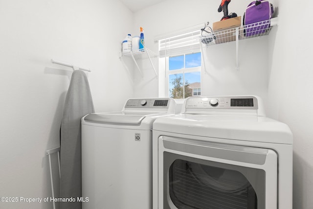 washroom featuring separate washer and dryer and laundry area