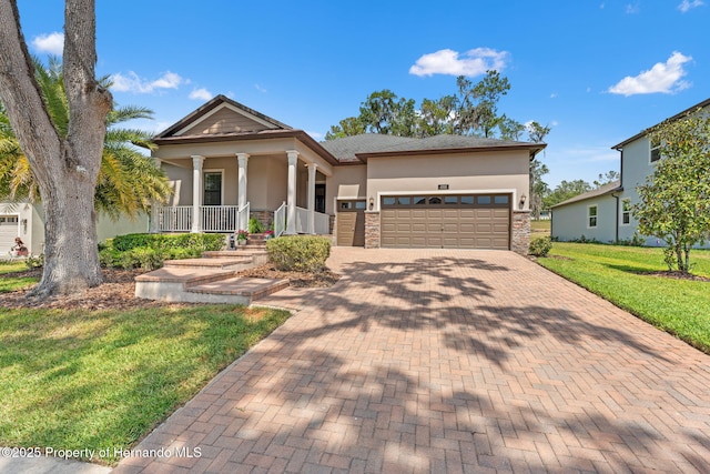 4910 Southern Valley Loop, Brooksville, FL 34601 - view of front facade featuring an attached garage, stucco siding, a porch, a front yard, and decorative driveway