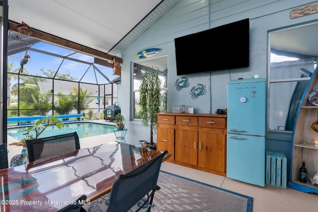 office with a healthy amount of sunlight, a sunroom, and lofted ceiling