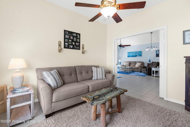 tiled living area featuring baseboards and ceiling fan