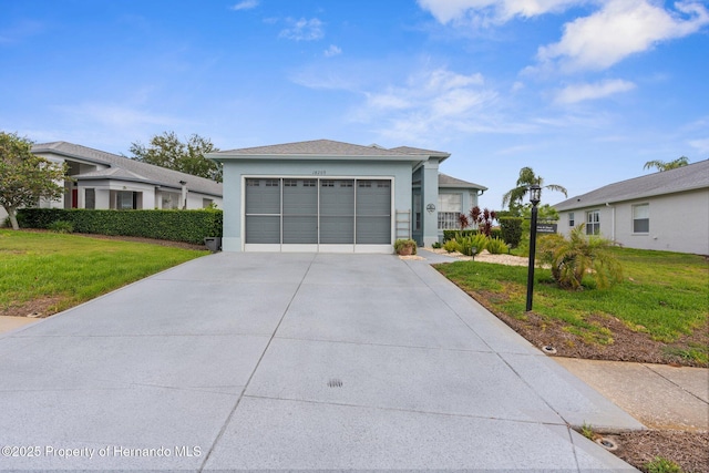 view of front of house featuring an attached garage, stucco siding, driveway, and a front yard