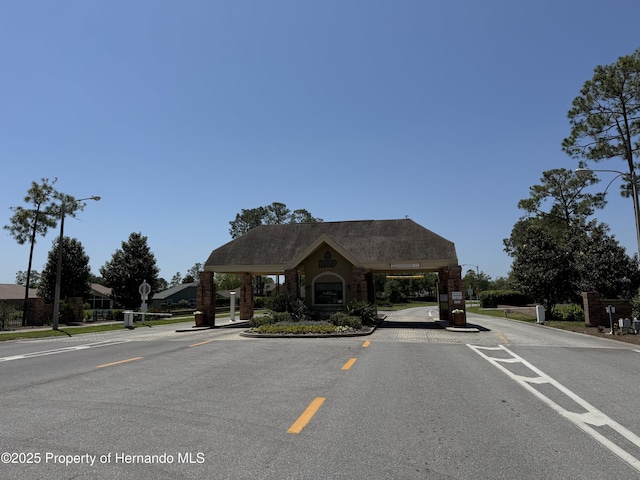 view of street with traffic signs, curbs, and street lights