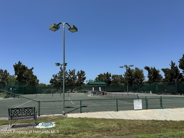 view of sport court featuring fence