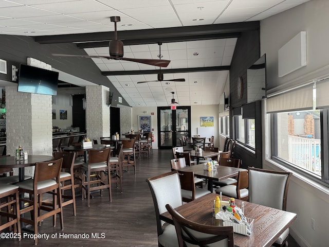 dining area featuring ceiling fan, vaulted ceiling, and wood finished floors