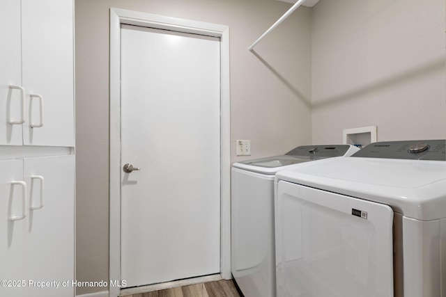 7423 Woodhollow Rd, Spring Hill, FL 34606 - laundry area featuring separate washer and dryer, laundry area, and wood finished floors