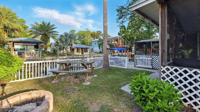 view of yard with fence and a sunroom