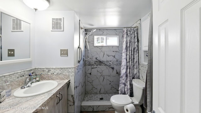 full bath with vanity, toilet, visible vents, and a stall shower