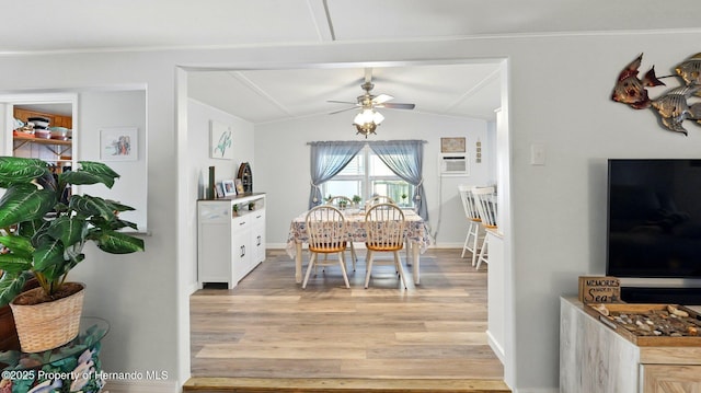 dining area with a ceiling fan, baseboards, lofted ceiling, ornamental molding, and light wood-style flooring
