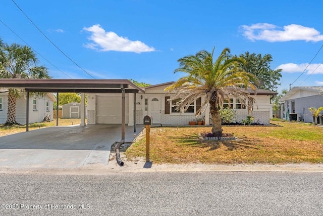 6424 Ponder Dr, Port Richey, FL 34668 - ranch-style house with a storage shed, brick siding, an attached garage, and a front lawn