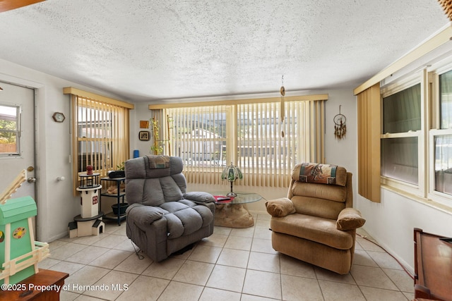6424 Ponder Dr, Port Richey, FL 34668 - living area featuring light tile patterned flooring, a textured ceiling, and baseboards