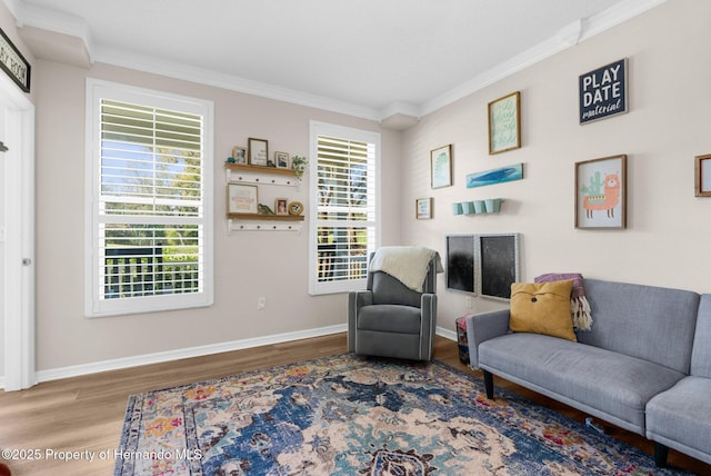 living area featuring crown molding, baseboards, a wealth of natural light, and wood finished floors