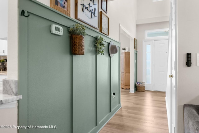 mudroom featuring light wood-style floors and baseboards