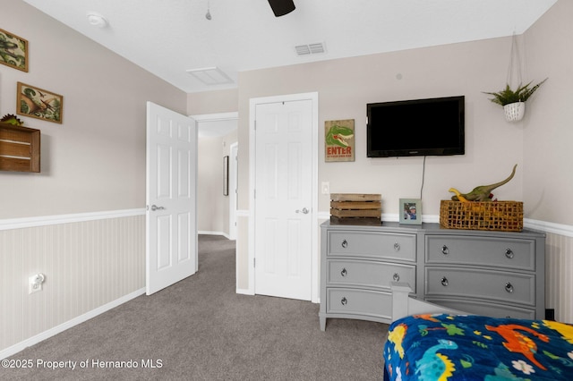 bedroom with carpet flooring, a ceiling fan, and visible vents