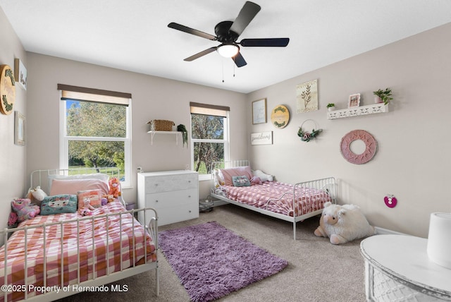 bedroom with a ceiling fan and carpet flooring
