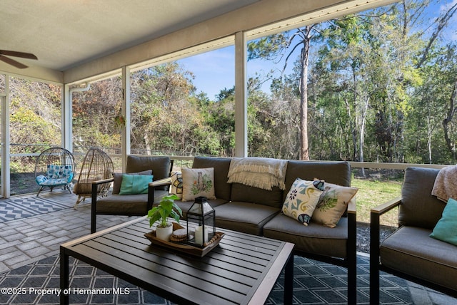 sunroom featuring ceiling fan and an outdoor hangout area