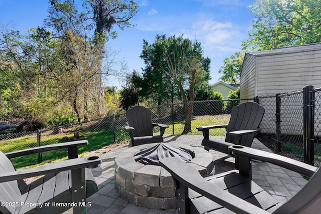 view of patio with a fenced backyard and a fire pit