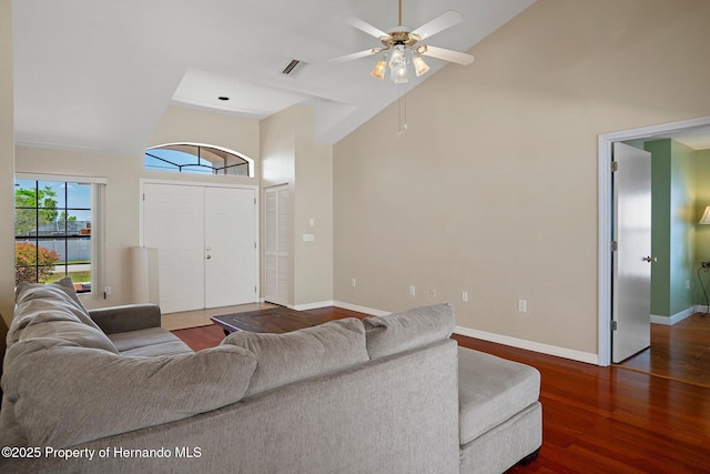 living area featuring ceiling fan, high vaulted ceiling, baseboards, wood finished floors, and visible vents