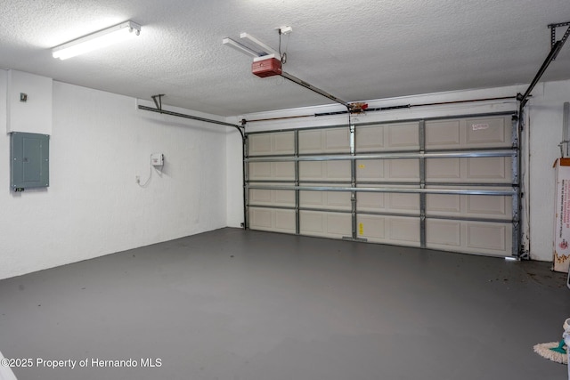 garage with a garage door opener and electric panel