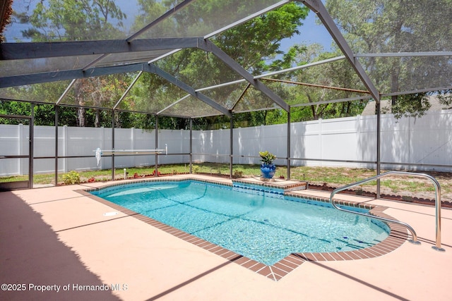 view of pool featuring a fenced in pool, a fenced backyard, glass enclosure, and a patio area