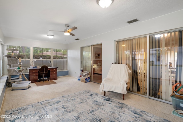 office area featuring visible vents, a ceiling fan, and carpet