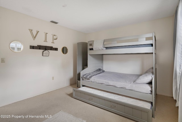 carpeted bedroom featuring visible vents