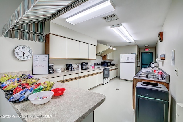 7644 St Andrews Blvd, Weeki Wachee, FL 34613 - kitchen featuring freestanding refrigerator, electric range oven, white cabinets, under cabinet range hood, and light countertops