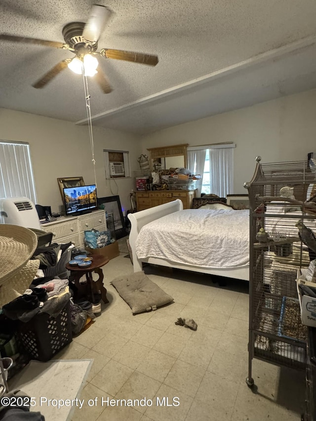 bedroom with a textured ceiling and tile patterned floors
