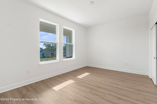 14042 Amero Ln, Spring Hill, FL 34609 - empty room with light wood-type flooring and baseboards