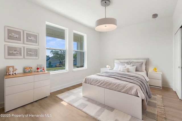 14042 Amero Ln, Spring Hill, FL 34609 - bedroom with baseboards and light wood-type flooring