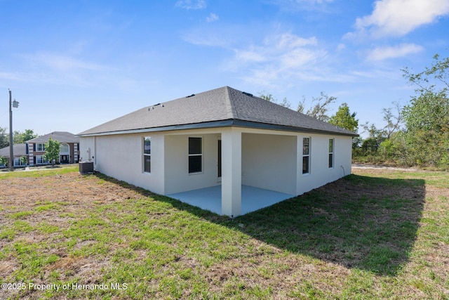 14042 Amero Ln, Spring Hill, FL 34609 - rear view of house featuring a yard, a patio area, central AC unit, and stucco siding