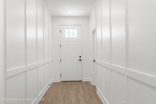 14042 Amero Ln, Spring Hill, FL 34609 - doorway to outside featuring light wood-type flooring and baseboards