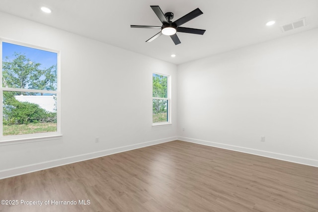 14042 Amero Ln, Spring Hill, FL 34609 - spare room with recessed lighting, baseboards, ceiling fan, visible vents, and wood finished floors