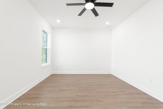 14042 Amero Ln, Spring Hill, FL 34609 - unfurnished room featuring baseboards, a ceiling fan, and light wood-style floors