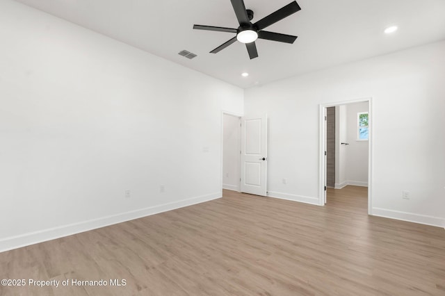 14042 Amero Ln, Spring Hill, FL 34609 - unfurnished bedroom with a walk in closet, light wood-style flooring, baseboards, and recessed lighting