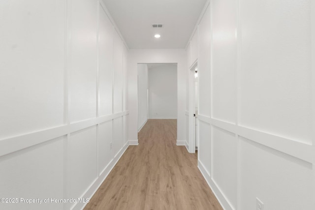 14042 Amero Ln, Spring Hill, FL 34609 - hall featuring light wood-type flooring, visible vents, baseboards, and recessed lighting