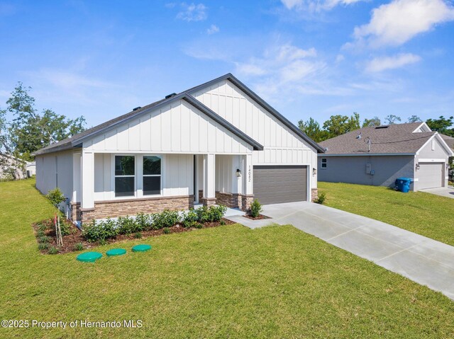 14042 Amero Ln, Spring Hill, FL 34609 - modern farmhouse featuring concrete driveway, board and batten siding, a front lawn, and an attached garage