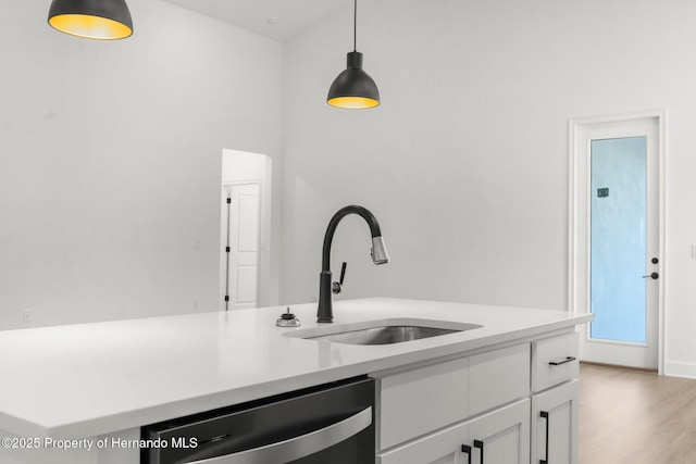 14042 Amero Ln, Spring Hill, FL 34609 - kitchen featuring a sink, pendant lighting, white cabinetry, light countertops, and stainless steel dishwasher