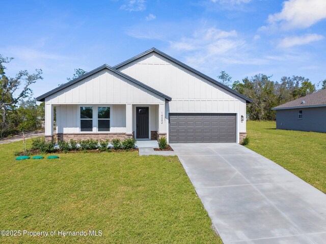 14042 Amero Ln, Spring Hill, FL 34609 - modern inspired farmhouse featuring a front lawn, board and batten siding, driveway, and a garage