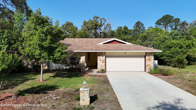 single story home featuring a front yard, stone siding, roof with shingles, an attached garage, and driveway