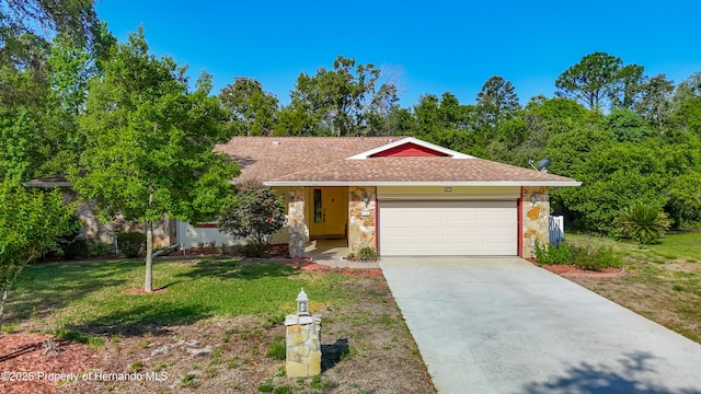 single story home with a front yard, a garage, concrete driveway, a shingled roof, and stone siding