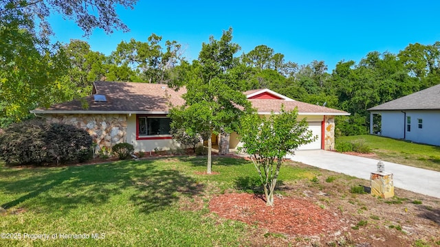 view of front of home with a front yard, stone siding, stucco siding, concrete driveway, and an attached garage