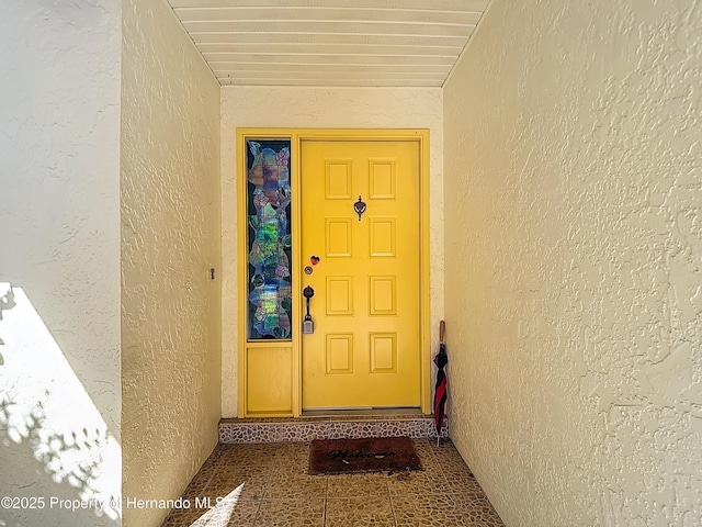view of exterior entry with stucco siding