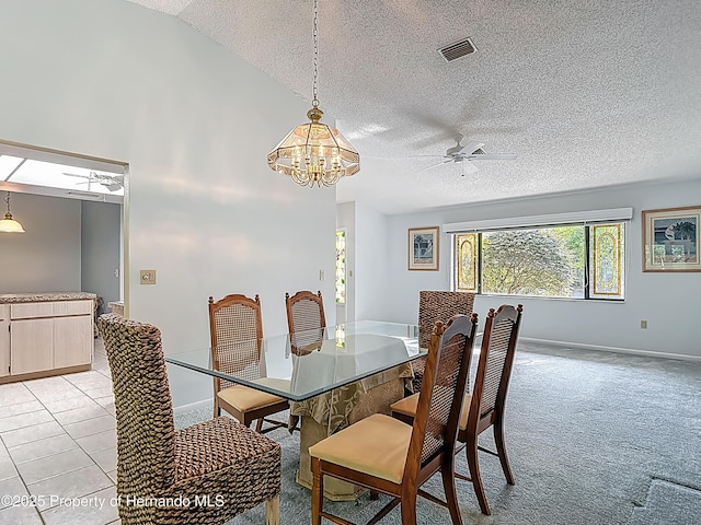 dining space with baseboards, ceiling fan with notable chandelier, a textured ceiling, and visible vents
