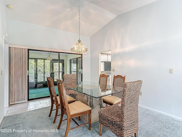 dining room featuring a textured ceiling, light colored carpet, high vaulted ceiling, baseboards, and a chandelier