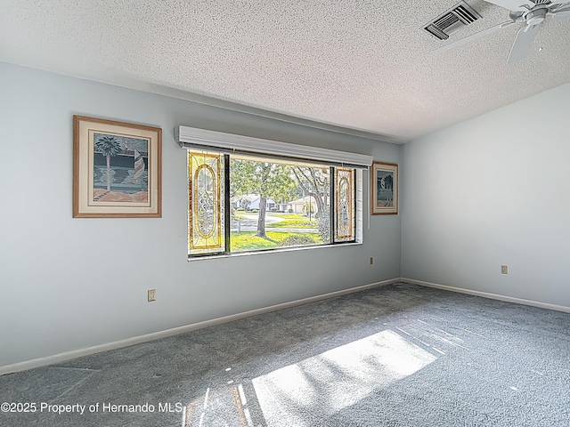 carpeted empty room with a ceiling fan, a textured ceiling, visible vents, and baseboards