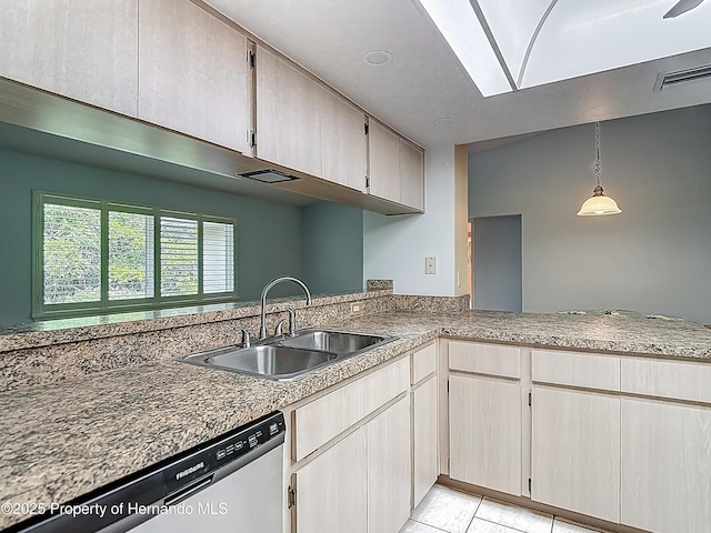 kitchen featuring visible vents, dishwasher, a sink, a peninsula, and light tile patterned flooring