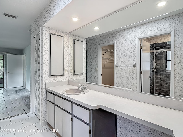 bathroom featuring visible vents, a stall shower, vanity, tile patterned floors, and recessed lighting