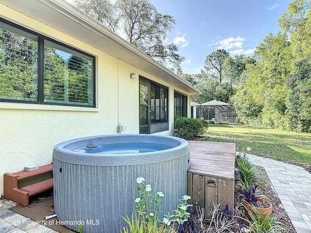 wooden terrace featuring central air condition unit, a hot tub, and a yard