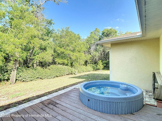 deck featuring hot tub deck surround