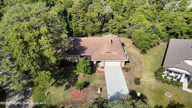 birds eye view of property with a view of trees